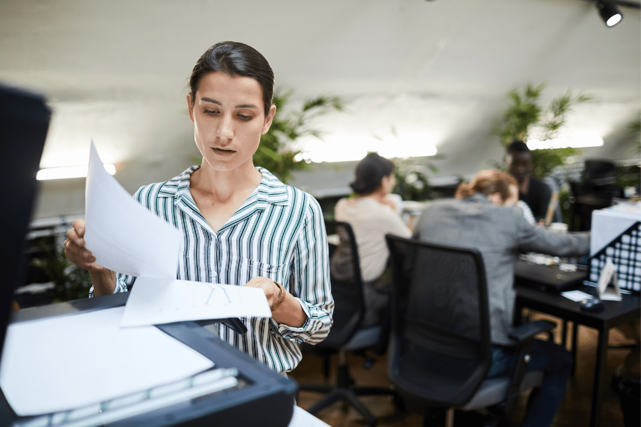 Managed print services woman printing documents in an office