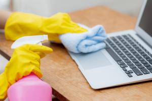cleaning laptop with cleaning products at home