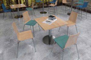 canteen style furniture in wood and different colours with wooden tables and high chairs