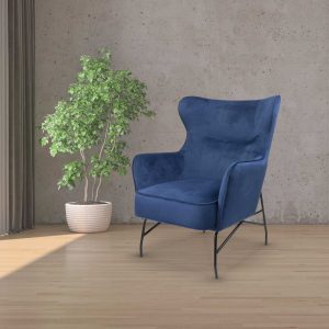 stylish velvet blue chair next to a standing plant
